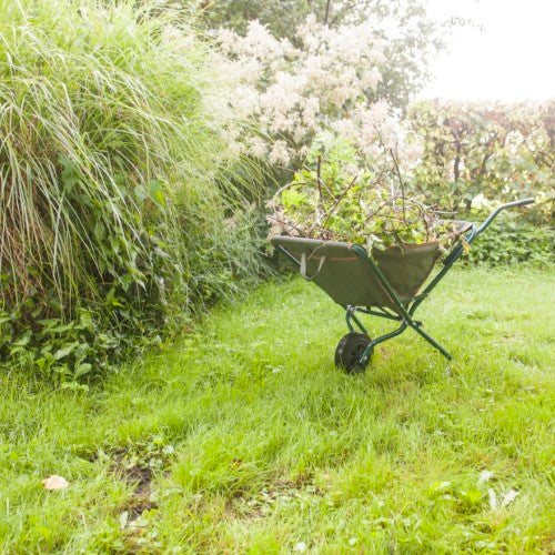 Foldable wheelbarrow with built-in tool compartments, perfect for lightweight gardening tasks and easy storage.