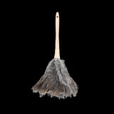 Feather duster with real ostrich feathers and ergonomic beech wood handle for gentle, effective dusting of delicate items.