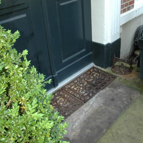 Cast iron doormat (34 x 58cm) with Victorian curls, adding elegance and durability to any entryway.