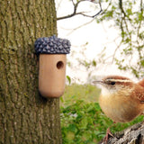 Acorn-shaped bird house made from FSC certified wood, designed for nesting and shelter in gardens, measuring 14 x 25 cm.