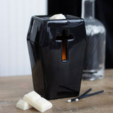Coffin-shaped oil burner with cross cutouts, illuminating ambient light; perfect for gothic decor and aromatherapy.