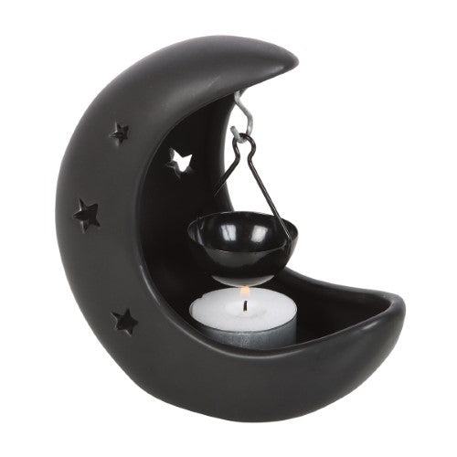 Black crescent moon oil burner with star cut-outs, perfect for creating a magical atmosphere and dispersing captivating scents.
