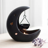 Black crescent moon hanging oil burner with star cut-outs, perfect for creating a magical ambiance and filling your space with scent.