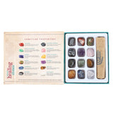 Set of 12 natural crystal gemstones in a magnetic box, promoting meditation and emotional healing with unique properties.