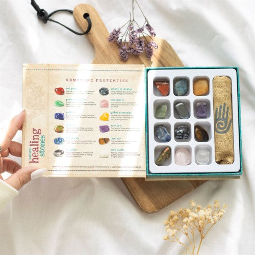 Set of 12 natural crystal healing gemstones in a magnetic box, featuring stones for emotional balance and spiritual growth.