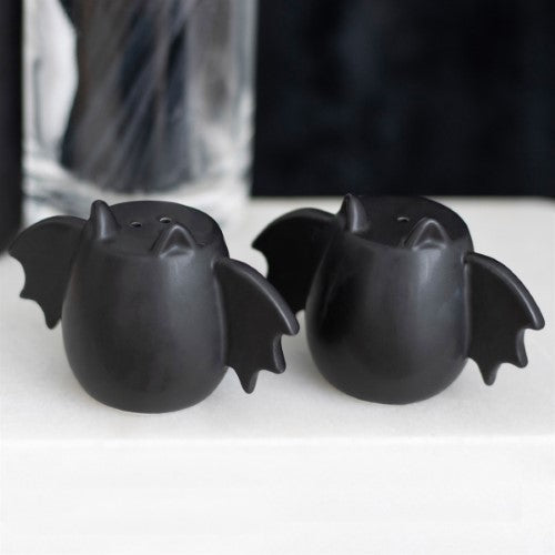 Whimsical bat wing salt and pepper shakers adding gothic charm to dining, perfect for Halloween or unique home decor.