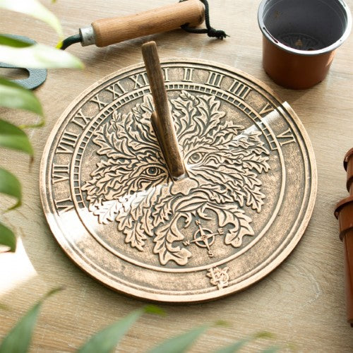 Terracotta sundial featuring a rustic Green Man design by Lisa Parker, perfect for garden decor and telling time.