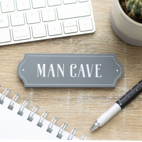 Vintage 'Man Cave Wall Plaque' showcasing masculinity, perfect for dad’s retreat, measuring H:4 x W:12 x D:O.6 cm.