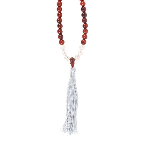 Elegant mala necklace featuring 108 rosewood beads and Clear Quartz, promoting mindfulness and stress relief with a decorative tassel.