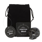Black Labradorite Crystal Skull in sleek black, 4x5x2 cm, promotes grounding and abundance, ideal for desk decor and spiritual work.