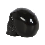 Handcrafted black obsidian crystal skull, 4x5x2 cm, perfect for decor, protection, and crystal healing, presented in a pouch.