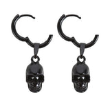 Black stainless steel skull earrings with intricate charms, ideal for gothic style and modern elegance in a bold statement piece.