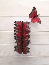Pack of 12 vibrant 9cm artificial Monarch butterflies, made from feathers with bendable wire for versatile decorating.