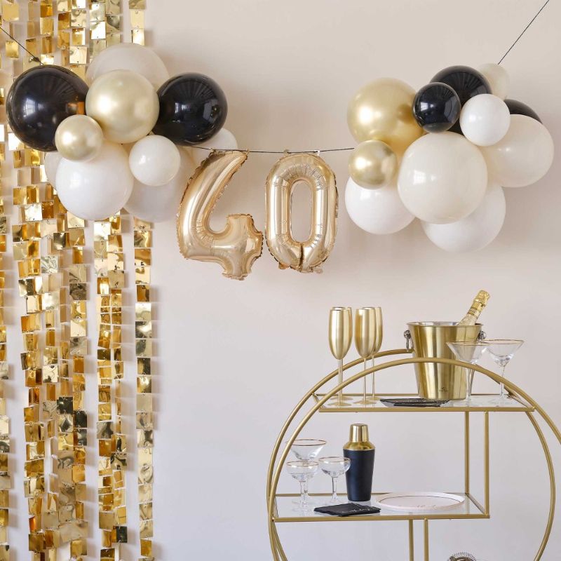 Elegant black and gold balloon bunting for celebrating a chic 40th birthday milestone. Perfect for stylish parties.