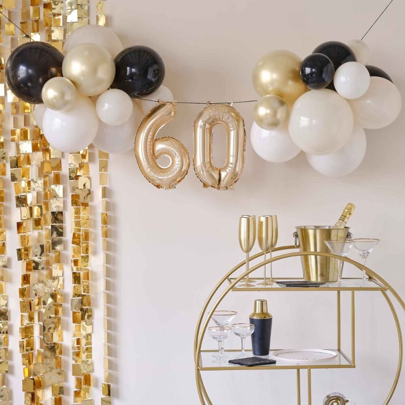 Elegant black and gold balloon bunting for a chic 60th birthday celebration, perfect for stylish decor and memorable photos.