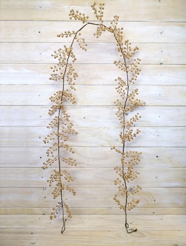 Six-foot artificial berry garland in luxurious gold, perfect for elegant home decor and festive celebrations.