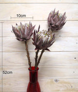 Medium artificial queen protea with a dry look, showcasing realistic details and vibrant color.