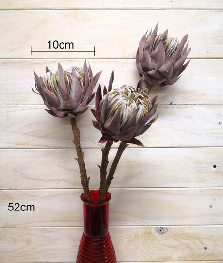 Medium artificial queen protea with a dry look, showcasing realistic details and vibrant color.