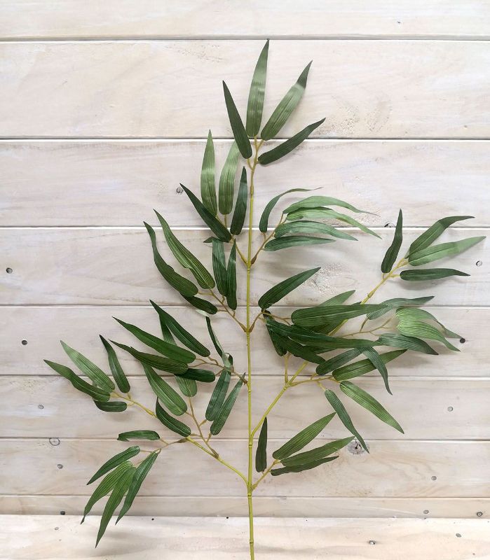 Vibrant artificial green and yellow bamboo spray for stylish home decor and floral arrangements.