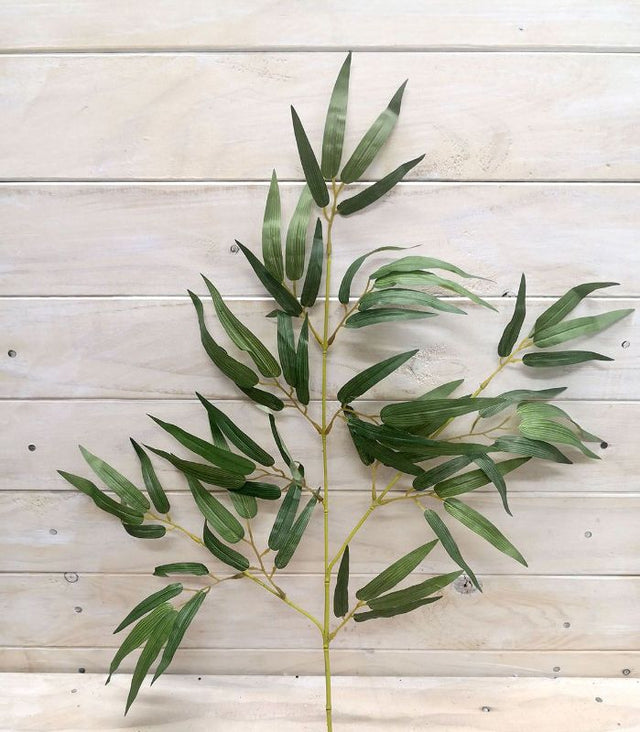 Vibrant artificial green and yellow bamboo spray for stylish home decor and floral arrangements.