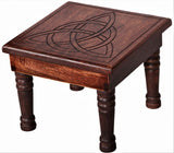 Handcrafted dark mango wood altar table featuring a carved Triquetra symbol, measuring 35cm for spiritual rituals and decor.