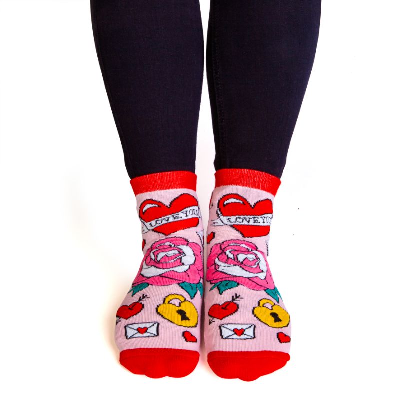 Bright pink and red socks with tattoo designs and anti-slip message "I F*CKING LOVE YOU" for cozy, bold expression.