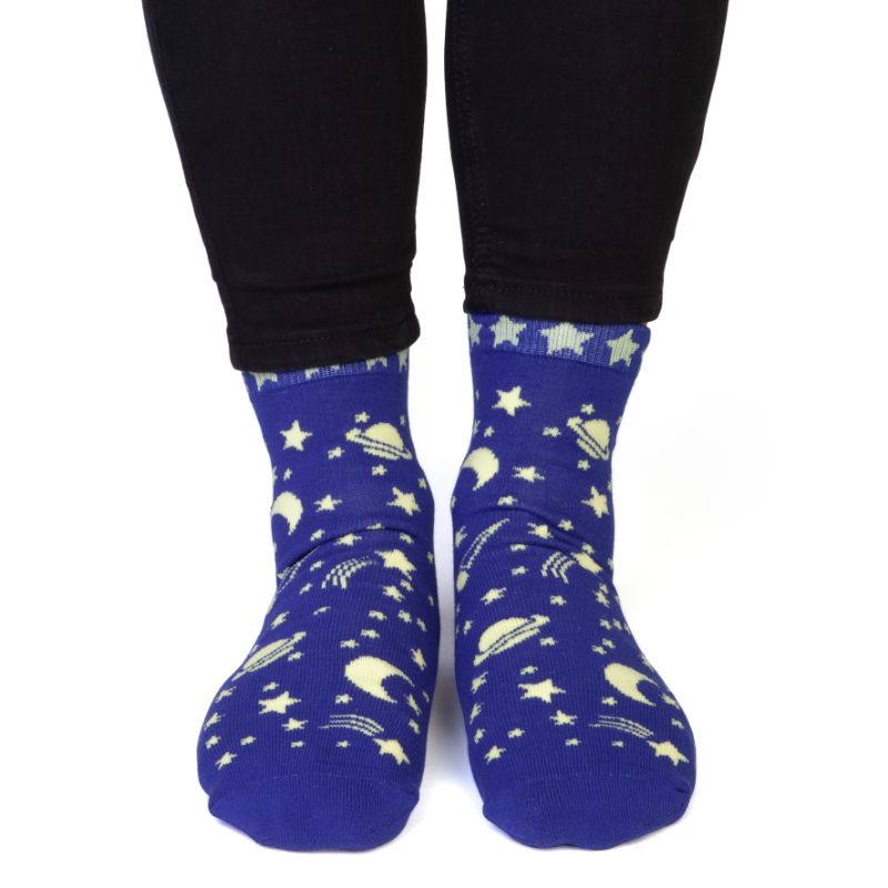 Vibrant socks featuring star and planet patterns with 'SPACED OUT' on the bottom, perfect for cosmic enthusiasts.