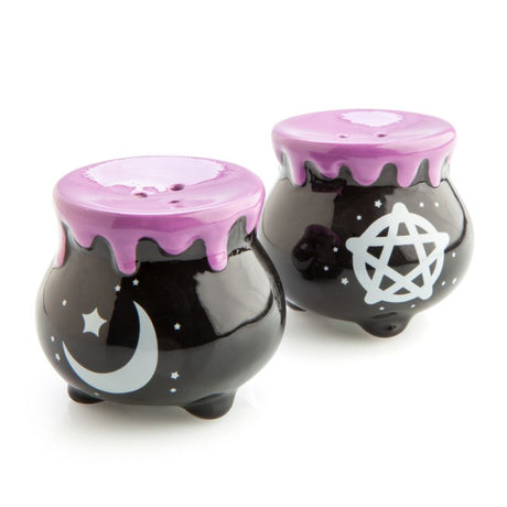 Whimsical cauldron-shaped salt and pepper shakers featuring a pentacle and crescent moon, adorned with purple drips.