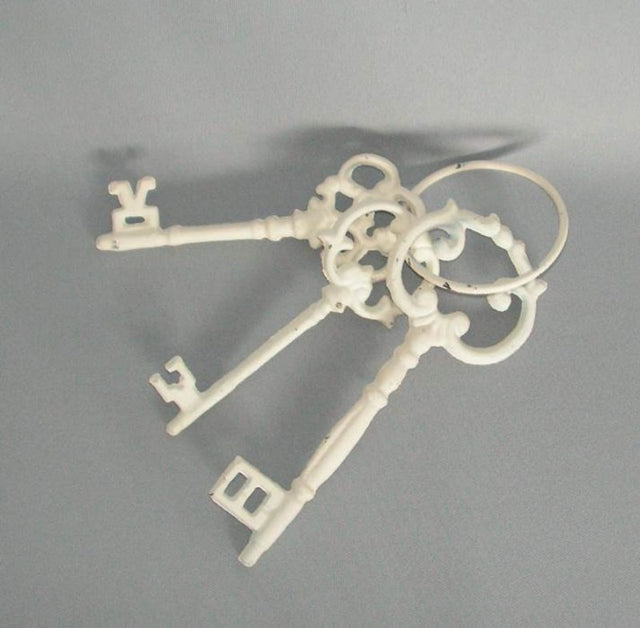 Three vintage-style cast iron keys, 15-20 cm long, showcasing intricate details, perfect for home decor and collectors.