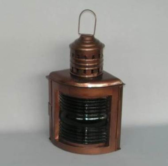 Green glass Ships Port Lamp with brass accents, featuring a meths burner for a warm glow, perfect for indoor or outdoor use.