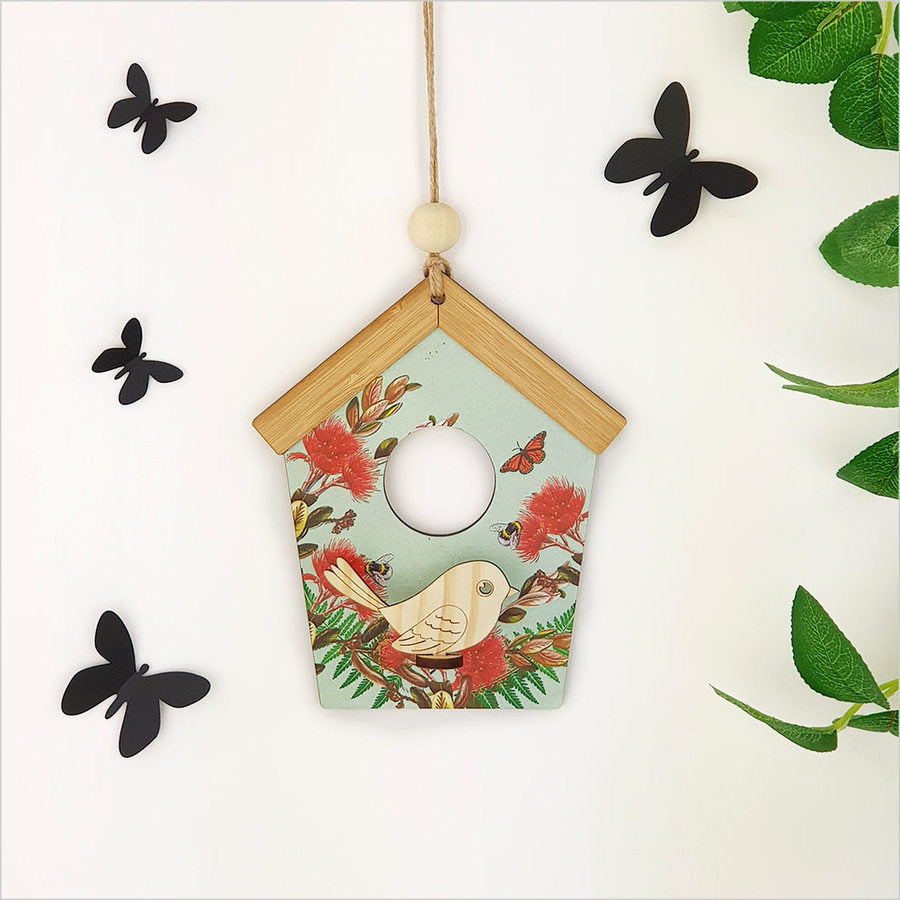 Laser-cut birdhouse wall art in vibrant green pohutukawa, crafted from durable MDF, ready to hang for nature-inspired decor.