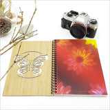 Small bamboo journal with intricate butterfly design, featuring 110 pages of 110gsm eco-friendly cartridge paper.