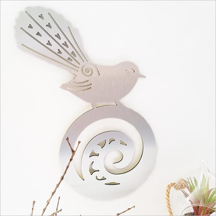 Kiwiana wall art featuring a New Zealand fantail on koru, crafted from durable ACM, ideal for indoor or outdoor decor.