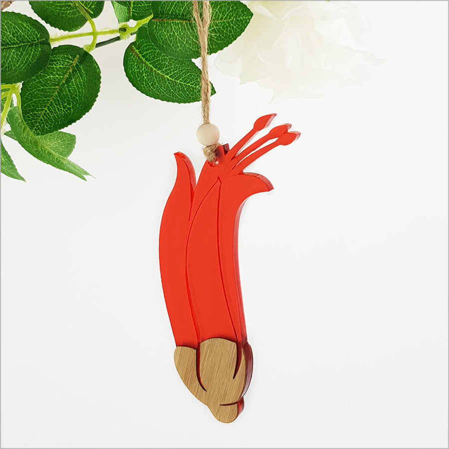 Stunning bamboo and red satin acrylic hanging ornament shaped like a flax flower, perfect for home decor and gifting.