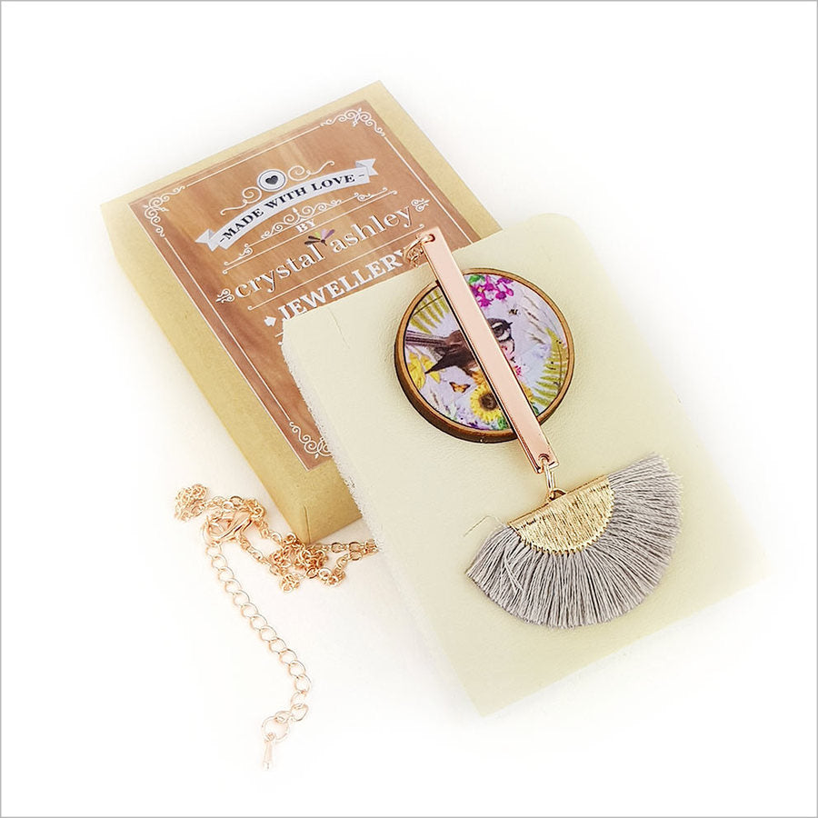 Tassel necklace featuring a floral fantail print on mother of pearl, rose gold finish, and 24" chain in a gift box.