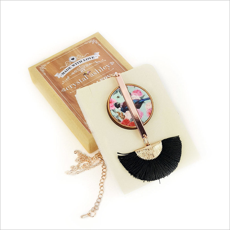 Floral Tui Tassel Necklace featuring rose gold pendant on mother of pearl, with a 24-inch chain and silk fan tassel.