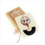 Floral Tui Tassel Necklace featuring rose gold pendant on mother of pearl, with a 24-inch chain and silk fan tassel.