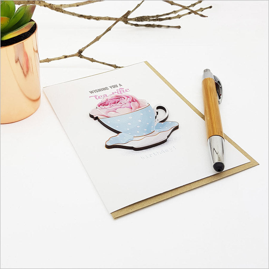 Greeting card featuring an embellished tea cup design, printed on premium textured cardstock, perfect for heartfelt messages.