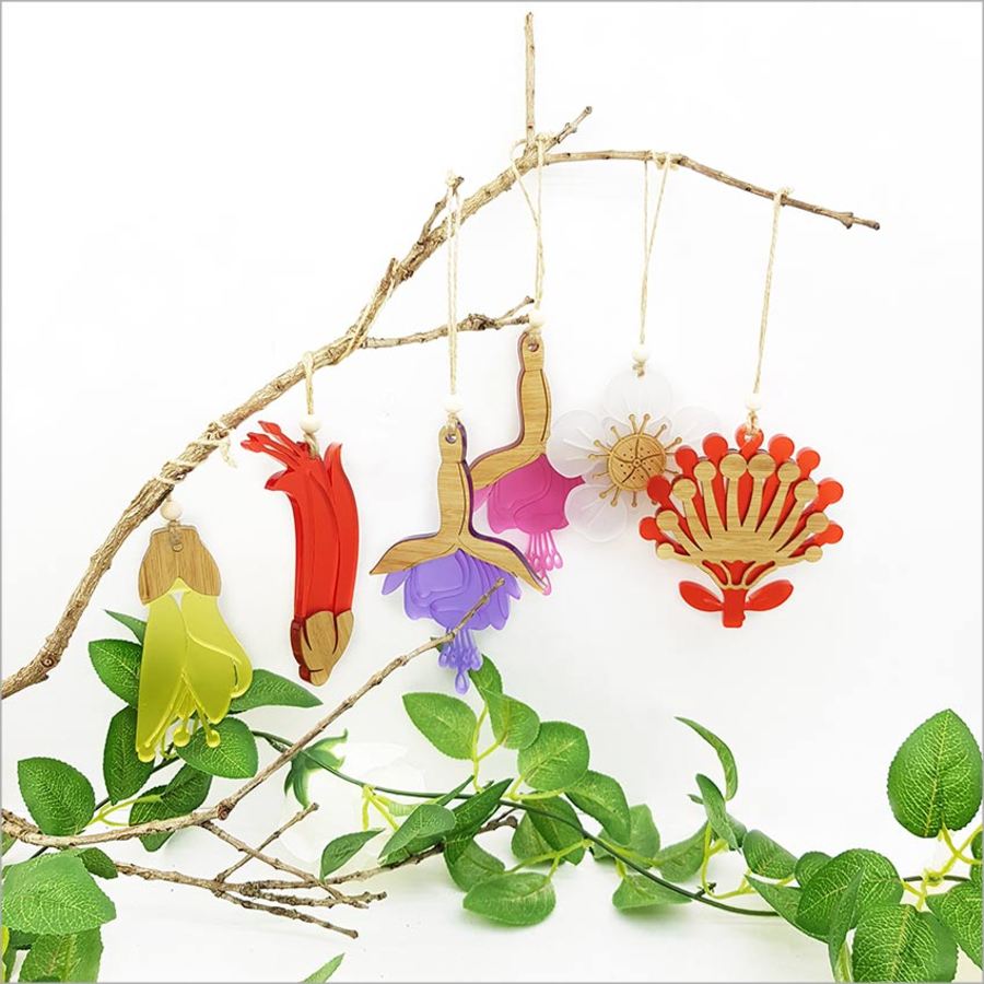 Elegant bamboo and white satin acrylic hanging ornament shaped like a Manuka flower, perfect for holiday decor and gifting.