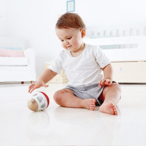 Hape Bell Rattle: a wooden, boomerang-shaped rattle with a gentle bell for sensory play and fine motor skill development.