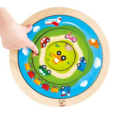 Hape Spinning Transport Puzzle featuring vibrant wooden vehicles, designed for toddlers to enhance motor skills and cognitive development.