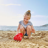 Bright red Hape Power Paw Toy for toddlers, perfect for outdoor sand and water play, encouraging creativity and active exploration.