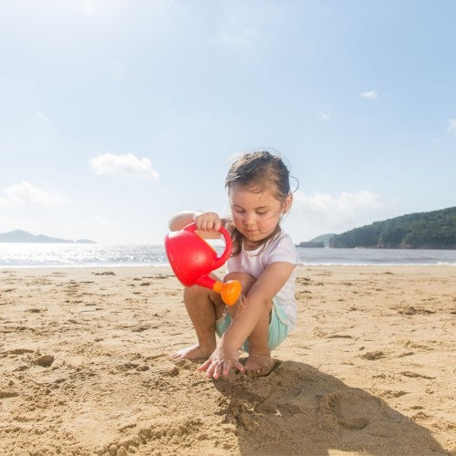 Bright red Hape watering can designed for toddlers, ideal for nurturing plants and encouraging imaginative gardening play.