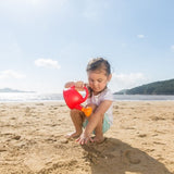 Bright red Hape watering can designed for toddlers, ideal for nurturing plants and encouraging imaginative gardening play.