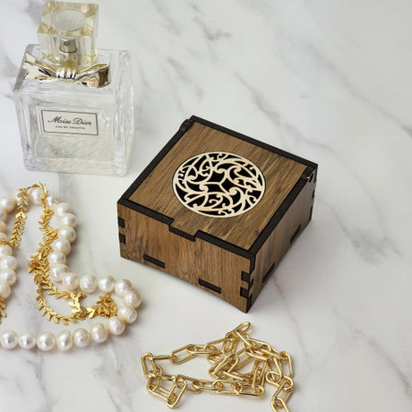 Trinket box made from reclaimed NZ riverwood, featuring unique colors and patterns, perfect for storing small treasures.