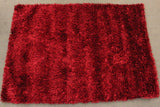 Handmade red shaggy rug (1.6 x 2.3m) featuring a soft texture, durability, and vibrant colors for stylish home decor.