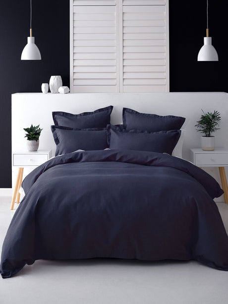 Elegant navy European pillowcase with textured 100% cotton waffle front and percale reverse, featuring tailored flange detail.