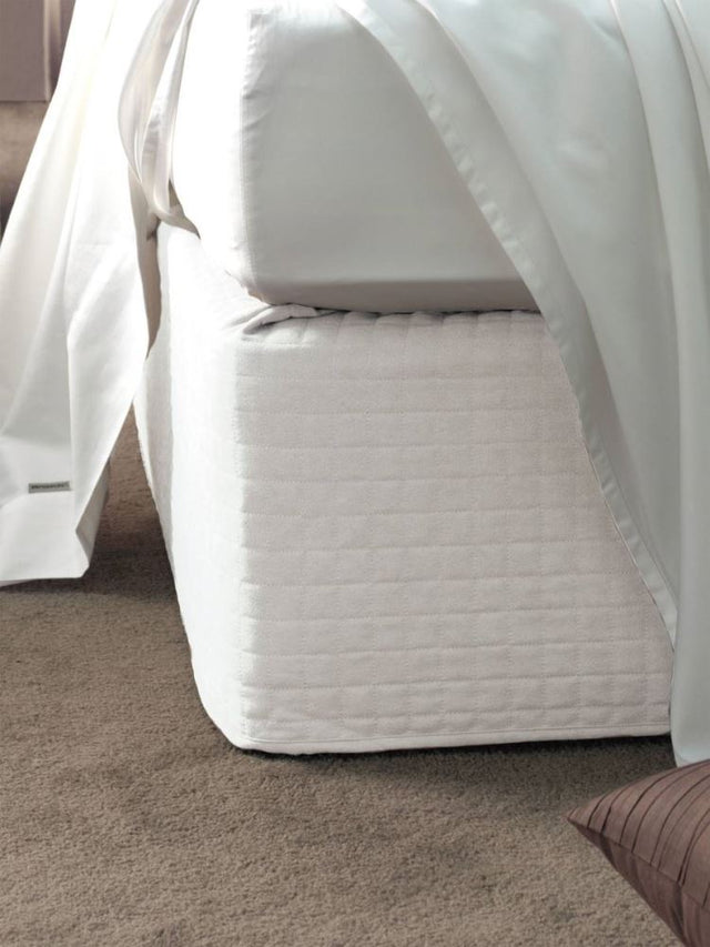 Elegant white suede quilted bed wrap for single beds, providing a chic finish without removing mattress or linens.