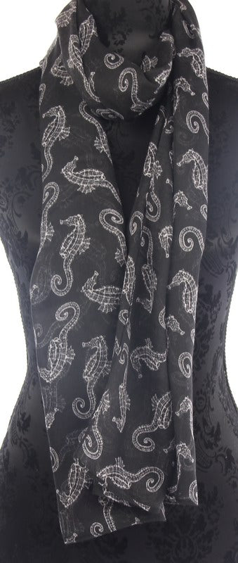 Elegant black scarf featuring a whimsical seahorse print, perfect for versatile styling and adding a touch of marine charm.