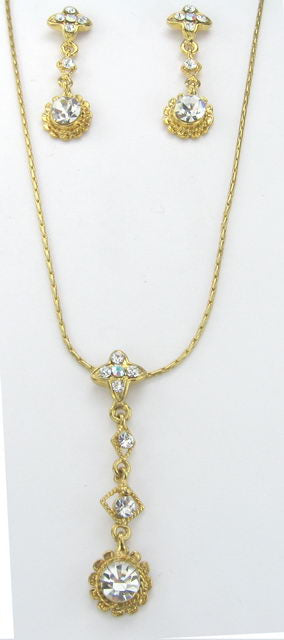 Gold earring and necklace set with dazzling diamante stones, perfect for elevating any outfit and making a statement.